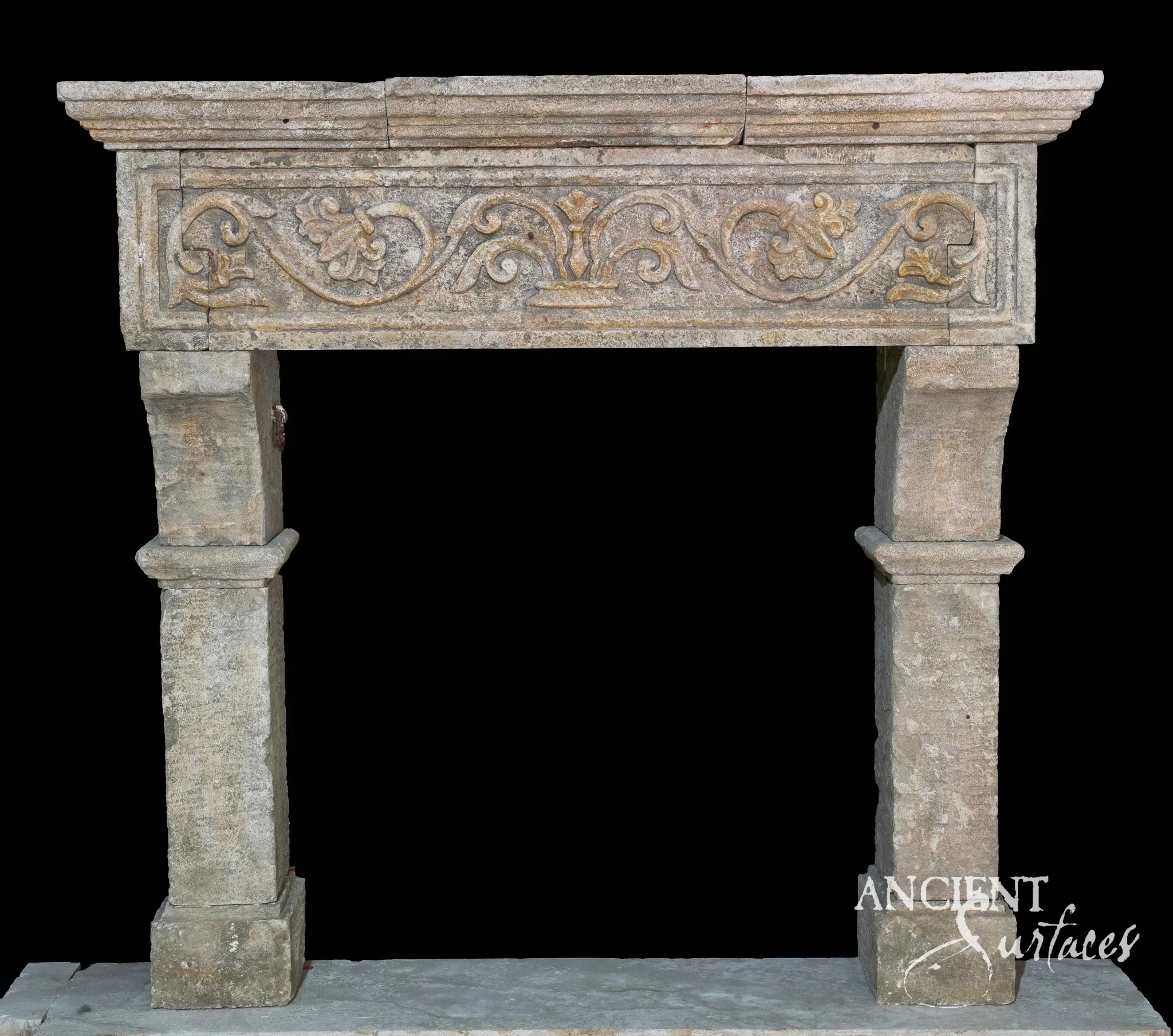 Reclaimed antique limestone mantel from Ancient Surfaces densely carved with scrolling acanthus leaves and traces of ochre toned pigment in the recesses